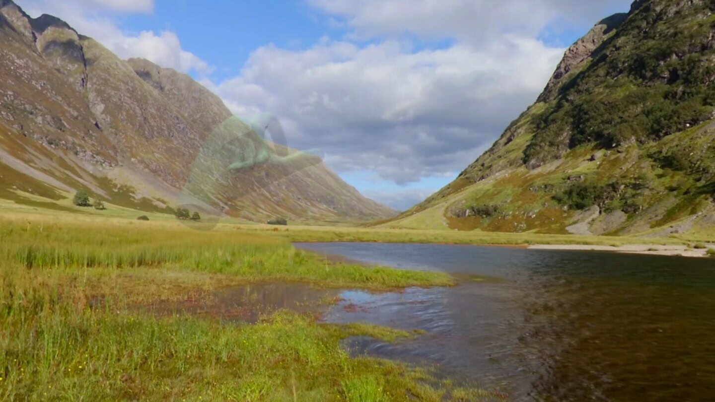 Highland valley and loch with a translucent hand reaching